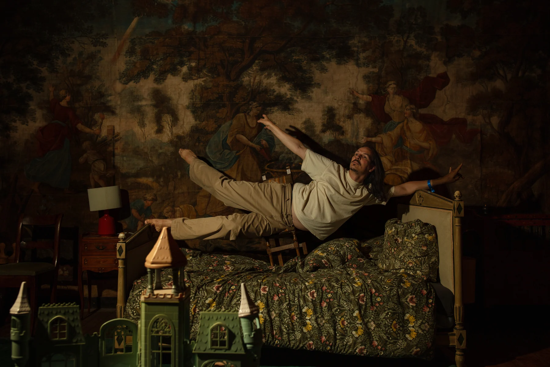 Outstretched above a bed