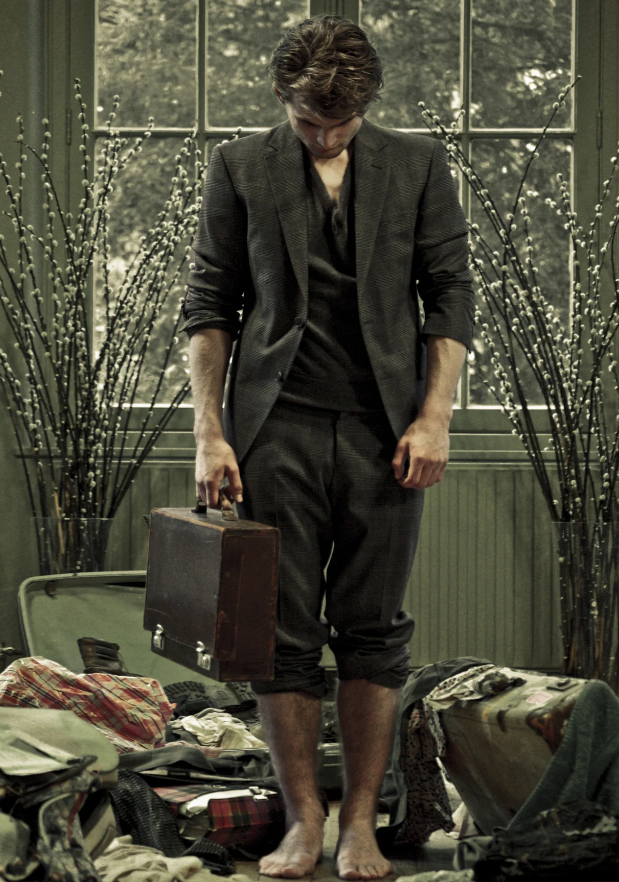 Figure in a suit among suitcases